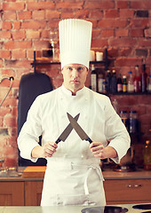 Image showing happy male chef cook in kitchen with knife