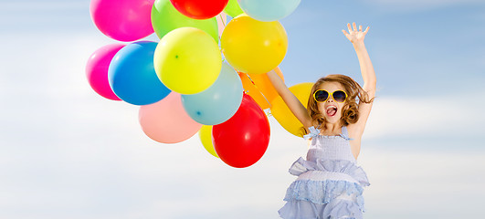 Image showing happy jumping girl with colorful balloons