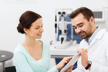 Image showing optician with tablet pc and patient at eye clinic