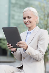 Image showing smiling businesswoman with tablet pc outdoors