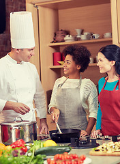 Image showing happy women and chef cook cooking in kitchen