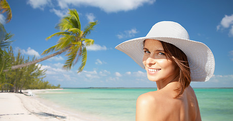 Image showing happy young woman in sunhat over summer beach