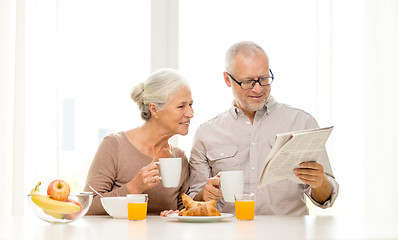 Image showing happy senior couple having breakfast at home