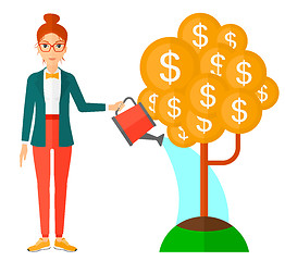 Image showing Woman watering money tree.