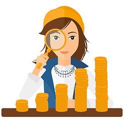 Image showing Woman with magnifier and golden coins. 