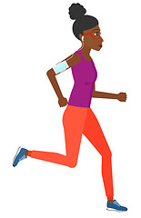 Image showing Woman jogging with earphones and smartphone.