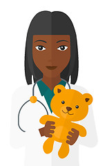 Image showing Pediatrician holding teddy bear.