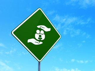 Image showing Insurance concept: Family And Palm on road sign background