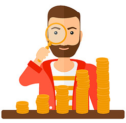 Image showing Man with magnifier and golden coins. 