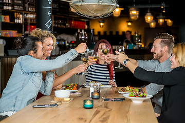 Image showing Friends Toasting Wineglasses At Restaurant