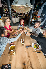 Image showing Friends Toasting Wineglasses At Table