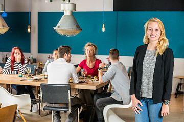 Image showing Portrait Of Happy Woman Standing At Restaurant