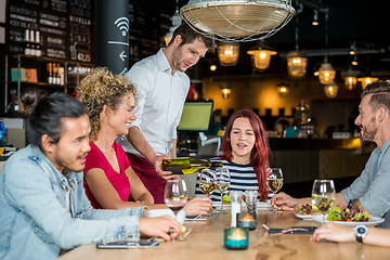 Image showing Waiter Serving Wine To Customers