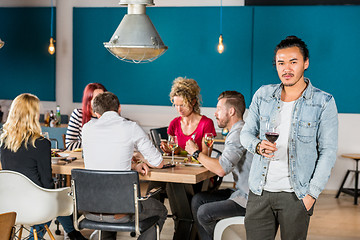 Image showing Confident Man Holding Wineglass At Cafe