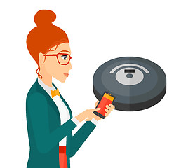 Image showing Woman with robot vacuum cleaner.