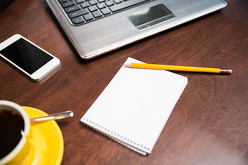 Image showing close up of notebook with pencil and laptop