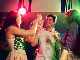 Image showing smiling friends with glasses of champagne in club