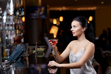 Image showing glamorous woman with cocktail at night club or bar