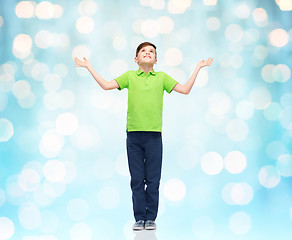 Image showing happy boy in polo t-shirt raising hands up