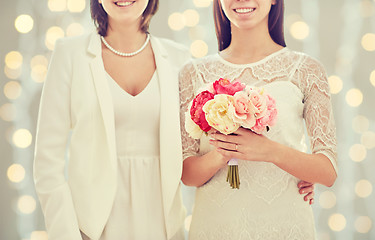 Image showing close up of happy lesbian couple with flowers