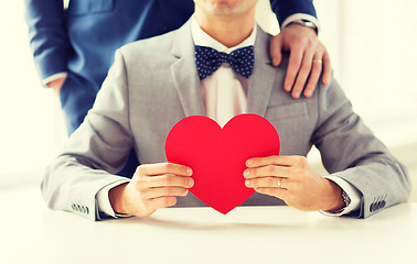 Image showing close up of male gay couple with red heart