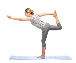 Image showing woman making yoga in lord of the dance pose on mat