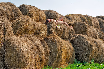 Image showing Attractive nude woman relaxes on hay