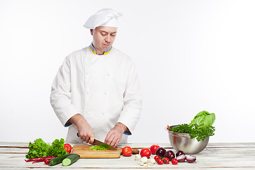 Image showing Chef cooking fresh vegetable salad in his kitchen