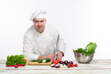 Image showing Chef posing with knife in his kitchen