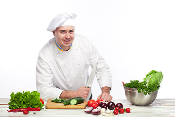 Image showing Chef posing with knife in his kitchen
