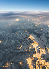 Image showing Mountains and clouds at sunset view from plane