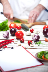 Image showing Chef cutting a green parsley his kitchen