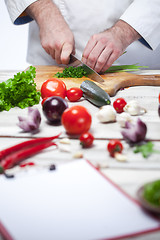 Image showing Chef cutting a green parsley his kitchen