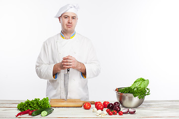 Image showing Chef posing with knife in his kitchen