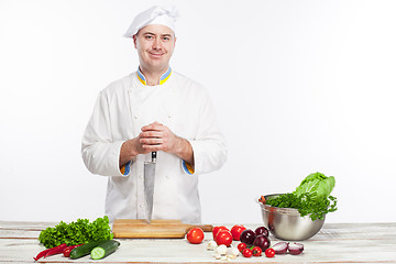 Image showing Chef posing with knife in his kitchen