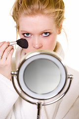 Image showing Putting on makeup