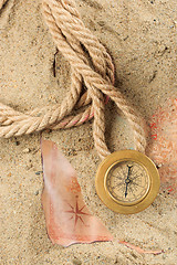 Image showing set of nautical instruments, lying on the sand and old map. concept adventure