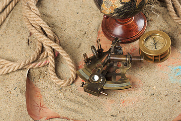 Image showing set of nautical instruments, lying on the sand and old map. concept adventure