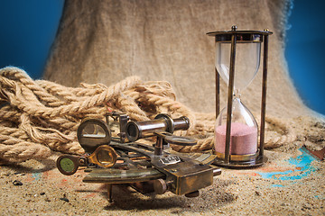 Image showing set of nautical instruments, lying on the sand and old map. concept adventure