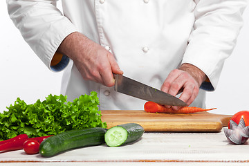 Image showing Chef cooking fresh vegetable salad in his kitchen