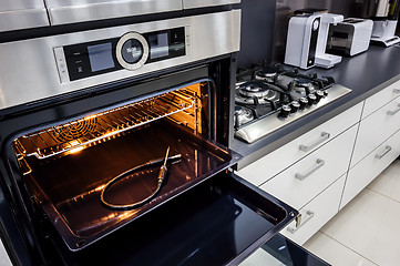 Image showing Modern hi-tek kitchen, oven with door open