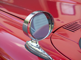 Image showing one side mirror on a red car