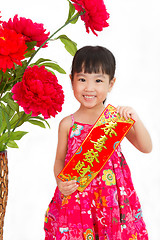 Image showing Chinese little girl pising holding  Spring festival couplets