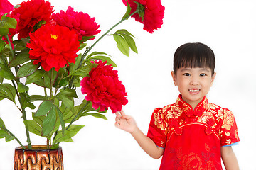 Image showing Chinese little girl wearing in Red posing with flowers