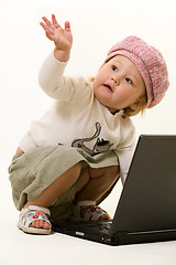 Image showing Adorable baby with laptop