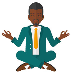 Image showing Businessman meditating in lotus pose.