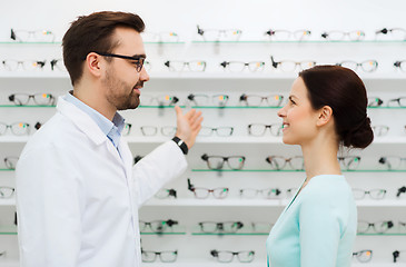 Image showing woman and optician showing glasses at optics store