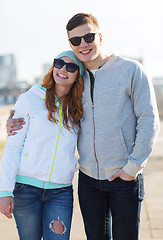 Image showing happy teenage couple walking in city