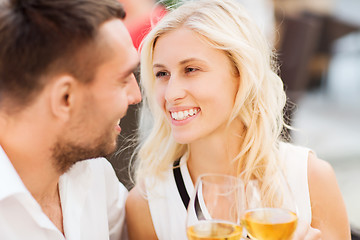 Image showing happy couple clinking glasses at restaurant lounge