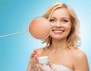 Image showing happy woman with cream jar